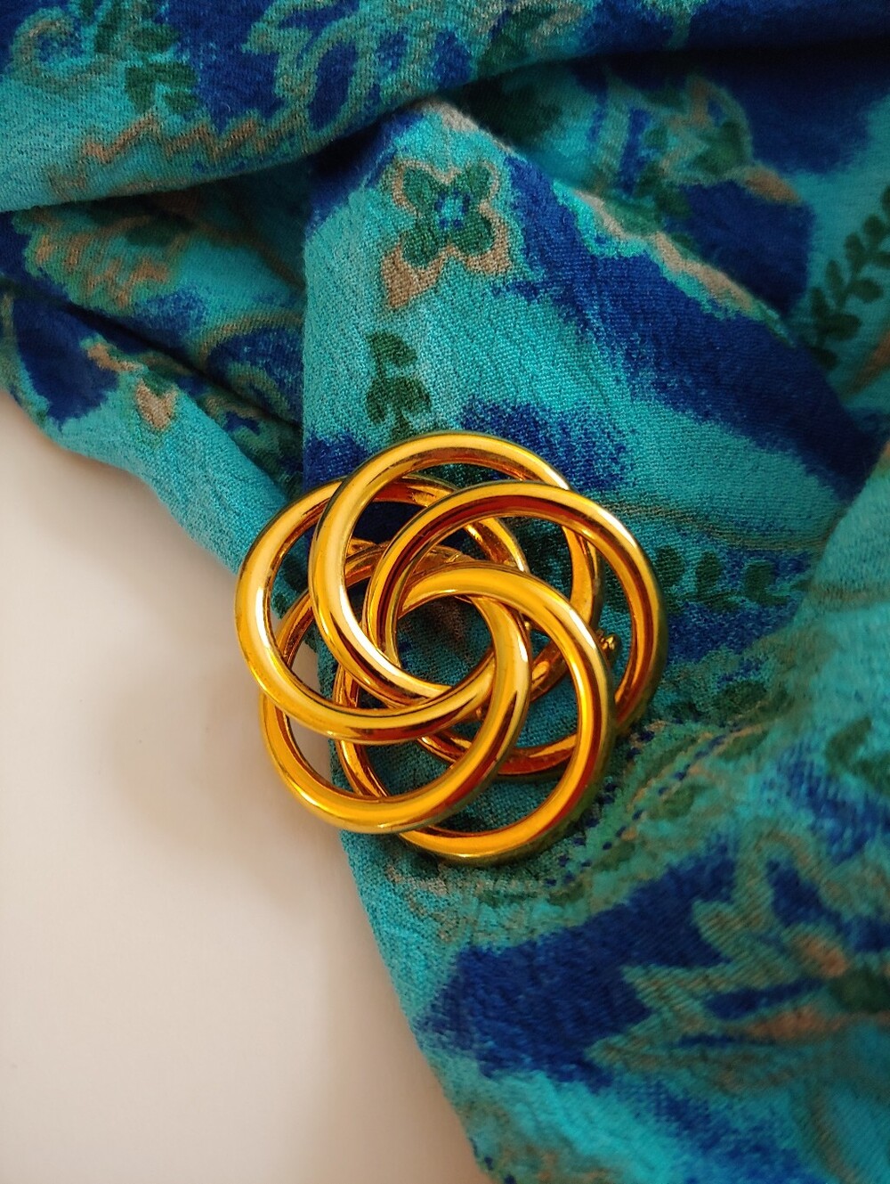 Napier Shiny Gold Tone Interlocking Knot Brooch